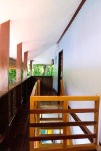 una escalera en una casa con barandilla de madera en Keyun's Inn- Across Cloud 9 en General Luna
