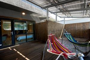 two hammocks on a deck with a bedroom at BONATHREE HOTEL in Busan