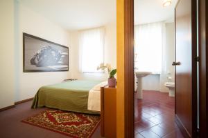a hotel room with a bed and a bathroom at Hotel Cima in Conegliano