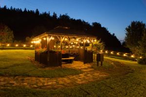 a gazebo lit up at night with lights at Hotel i Apartamenty pod Śnieżnikiem in Stronie Śląskie