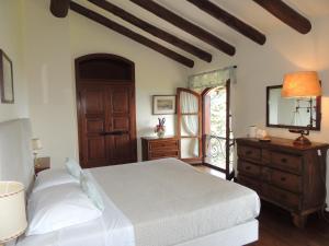 a bedroom with a bed and a dresser and a window at The Golf Club Guest House in Menaggio