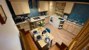 an overhead view of a small kitchen with a table at Spacious luxury flat in Swanage, close to beach in Swanage