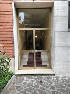 an entrance to a house with a glass door at Sweet Apartment Mecenate in Milan
