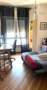 a bedroom with a bed and a desk and a table at B&B Stanze Lussuose in Aversa