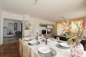 a dining room and living room with a table and chairs at Holiday house TINA Savudrija in Savudrija