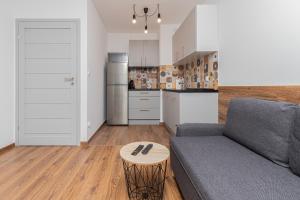 a living room with a couch and a table at Rewita Wrzeszcz Apartments by Renters in Gdańsk