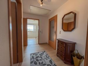 a room with a mirror and a dresser and a hallway at Ferienwohnung in ruhiger Waldrandlage in Bärenstein