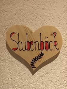 a wooden heart with the word studebaker on a wall at Ferienwohnung Stubenböck in Achenkirch