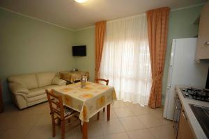 a living room with a table and a couch at B&B Villa Maria in Catanzaro