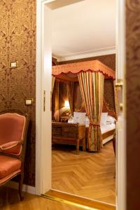 a door leading to a bedroom with a canopy bed at Hotel Antico Doge - a Member of Elizabeth Hotel Group in Venice