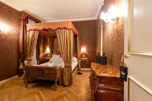 a bedroom with a bed with a canopy at Hotel Antico Doge - a Member of Elizabeth Hotel Group in Venice