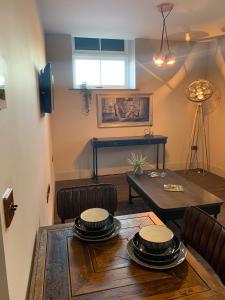 a living room with a table and chairs and a dining room at Oddfellows Hall in Thetford