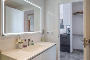 a white bathroom with a sink and a mirror at Marina view two bedroom apartment in Fuengirola +15 photos