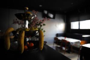 a bowl of fruit on a table with bananas at Hotel Sant Celoni in San Celoni