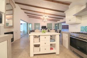 a kitchen with a white island in a room at Over the Moon in Paternoster