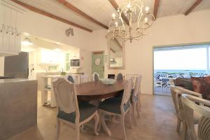 a kitchen and dining room with a table and chairs at Over the Moon in Paternoster