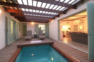 a swimming pool in a house with a pergola at Over the Moon in Paternoster