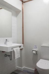 a bathroom with a toilet and a sink and a mirror at ELHIERRO BED&LOFT in Valverde