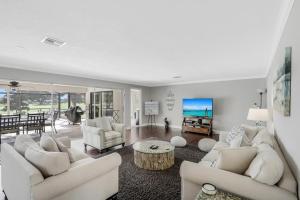 a living room with two couches and a table in it at 216 Shadowridge Court in Marco Island
