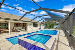 an image of a swimming pool with a pergola at 216 Shadowridge Court in Marco Island