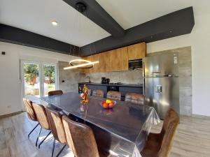 a dining room with a table and chairs in a kitchen at Holiday house Kazali, Medulin in Medulin