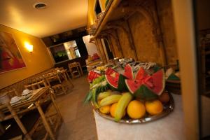 a bowl of fruit on a counter in a room at Hotel Rainero in Asti