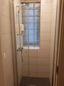 a shower in a bathroom with a window at City Hostel Bergen in Bergen