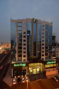 فندق روف جدة في جدة: فندق فيه سيارات تقف امام مبنى