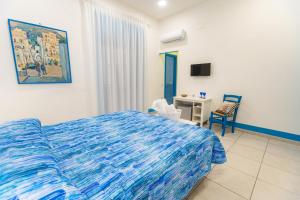 a bedroom with a bed and a desk and a chair at Biù b&b in Castellammare di Stabia