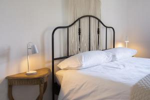 a bedroom with a bed and a table with a lamp at Ca Sander in Caprino Veronese
