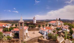 an aerial view of a village with a clock tower at Termas da Sulfurea in Cabeço de Vide