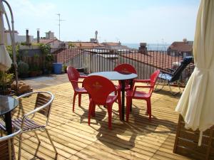 a dining room table with chairs and a patio at Hostal Platja in Cambrils