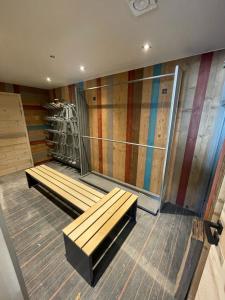 a room with two benches and a colorful wall at The French Lodge in Peisey-Nancroix