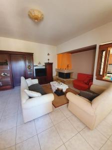 a living room with two couches and a table at My village home in Ioannina +14 photos
