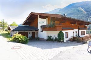 a large building with a driveway in front of it at Appartement Schöne Aussicht in Saalbach Hinterglemm
