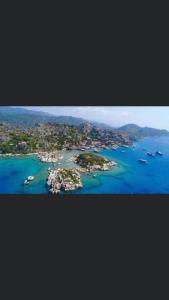 an island in the ocean with boats in the water at Nefes evleri in Demre