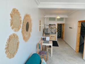a living room with two mirrors on the wall at Casa Lucía in Sidi Ifni