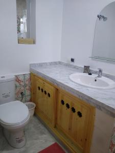 a bathroom with a sink and a toilet at Casa Lucía in Sidi Ifni