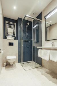a bathroom with a shower, toilet, and sink at Air Hotel in Warsaw