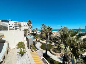 an aerial view of a resort with a pool and palm trees at Breathtaking Apartment in Torrevieja