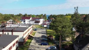 an aerial view of a small town with cars parked at Złota Rybka Natura Tour in Dziwnówek