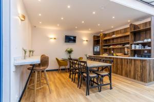 a dining room with a table and chairs at Atlantic Hotel Rennes Centre Gare in Rennes