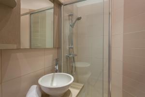 a bathroom with a toilet and a glass shower at DIFY Le Franklin - Bellecour in Lyon