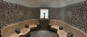 a large tiled bathroom with a jacuzzi tub with a person in at SPA-Hotel Dodo in Zhytomyr