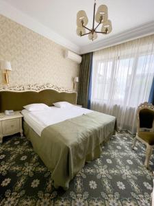 Postel nebo postele na pokoji v ubytování Olympic Hotel