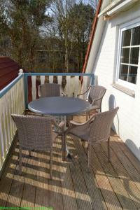 una mesa de patio y sillas en una terraza en Maisfeld Wohnung, en Wyk auf Föhr