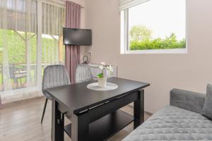 a living room with a table and a couch at Royal Resident in Druskininkai