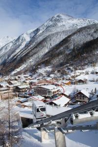 a town in the snow with a mountain at Hotel Hubertus inklusive Summercard in Sölden