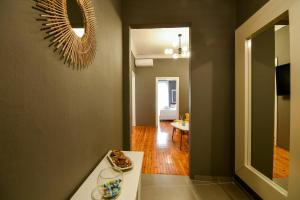 a living room with a table and a mirror at Thessaloniki Center Superior Apartment in Thessaloniki