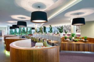 a restaurant with a bunch of chairs and tables at Botanique Hotel Prague in Prague